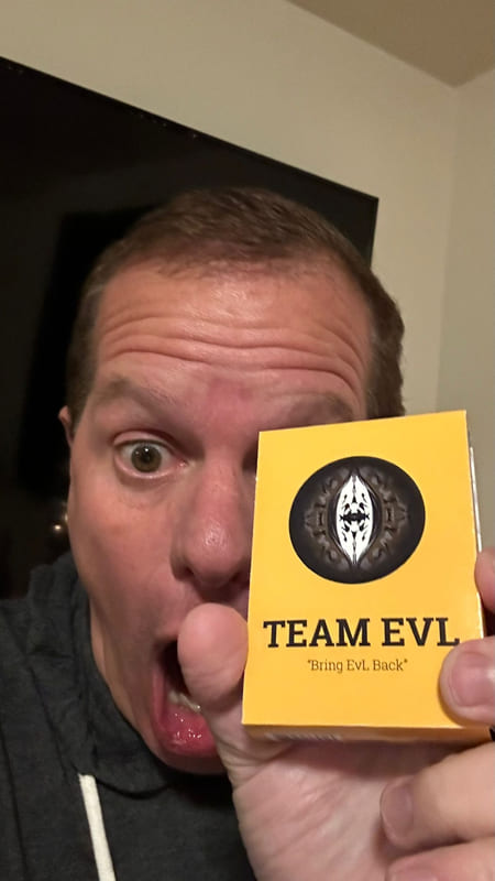 A player pulling a face behind the Team EvL box held up to the camera